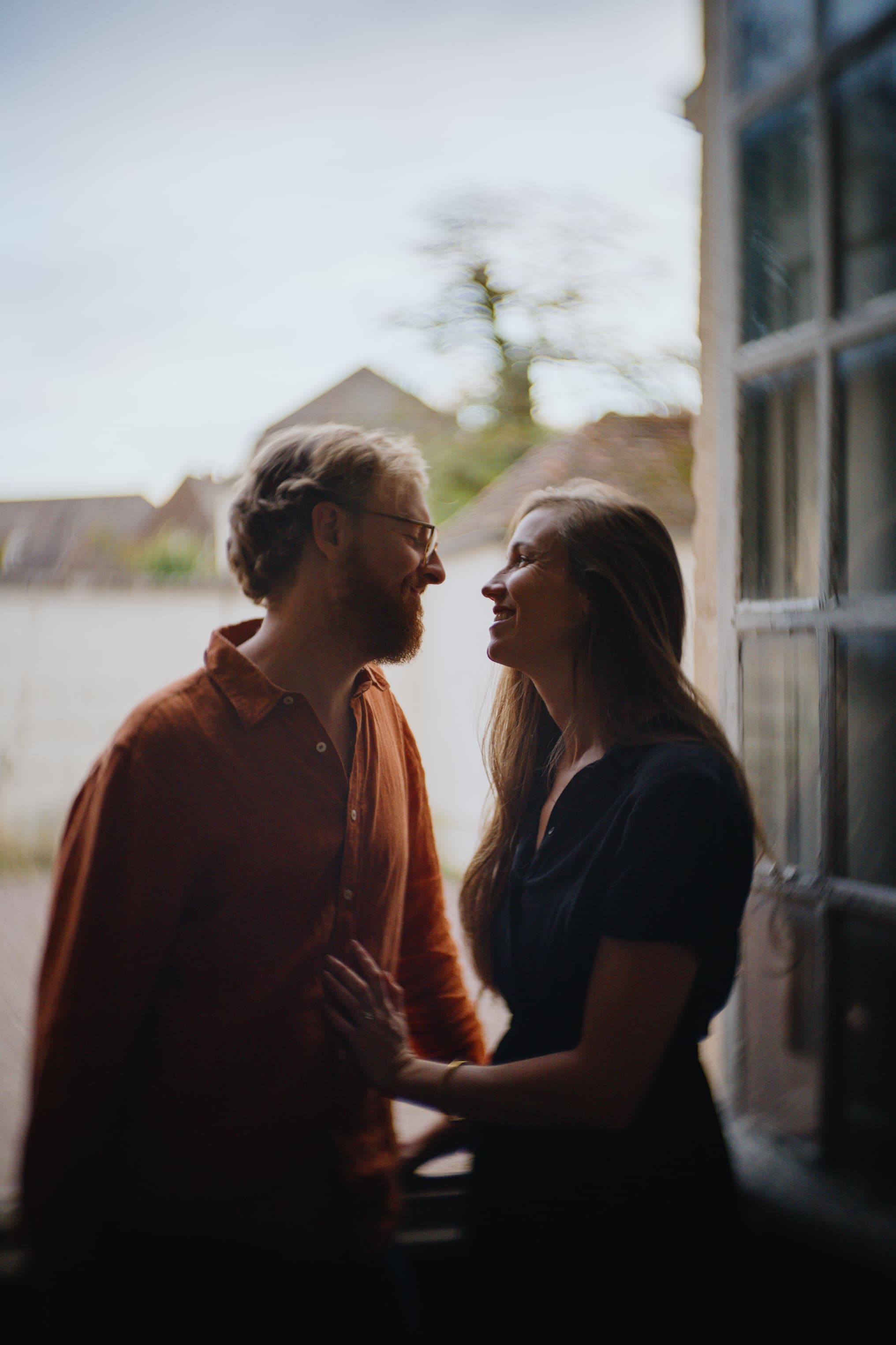 a young couple sitting in a window